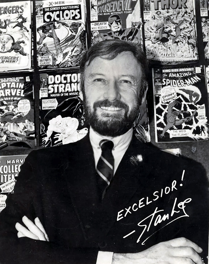 Picture of a young Stan Lee in front of classic marvel comics he wrote